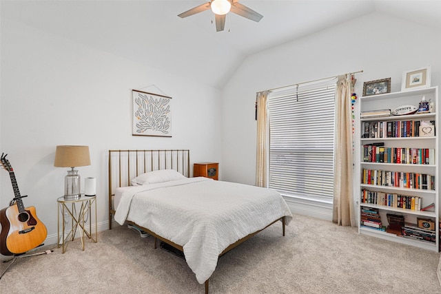 bedroom featuring a ceiling fan, baseboards, lofted ceiling, and carpet floors