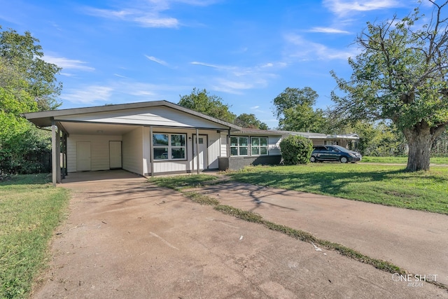 ranch-style house featuring a front yard and a carport