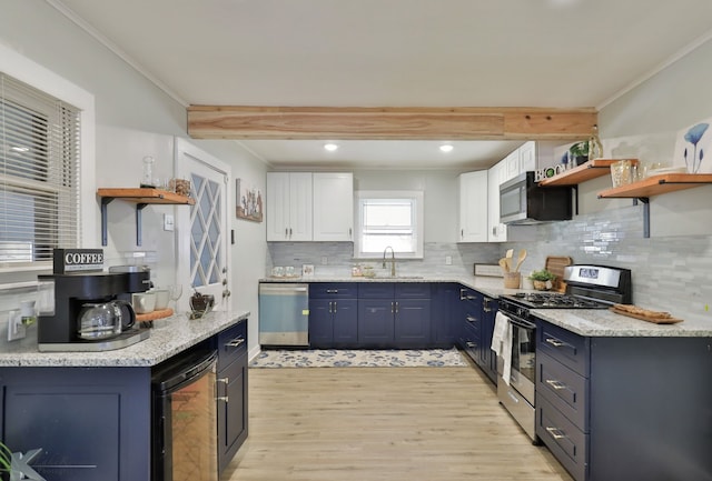 kitchen featuring wine cooler, white cabinets, light wood-type flooring, crown molding, and stainless steel appliances