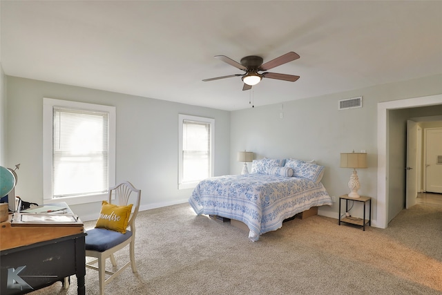 bedroom with ceiling fan and light carpet