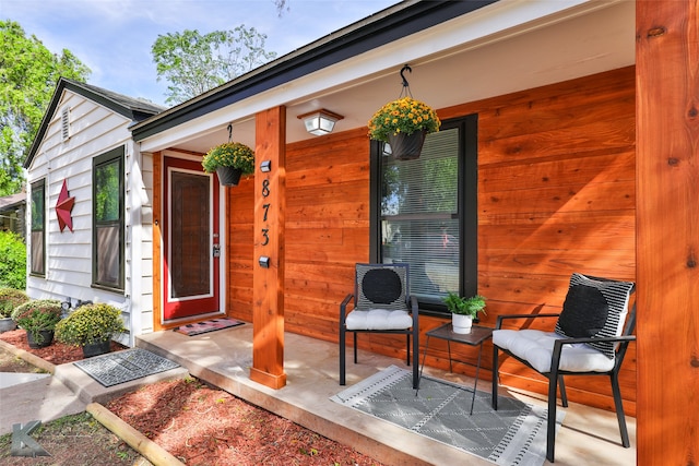 view of exterior entry featuring covered porch