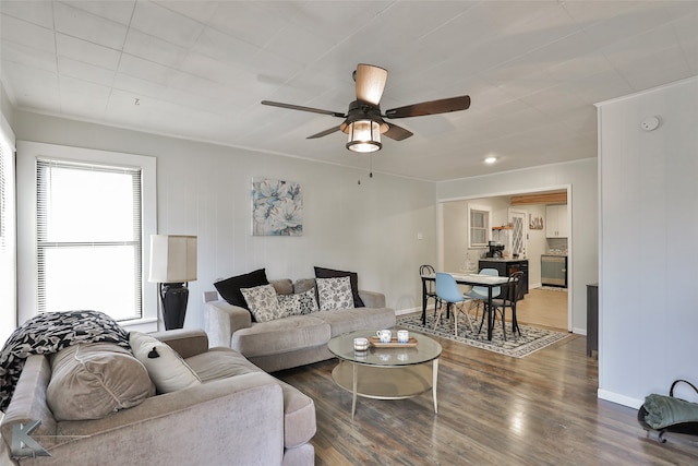 living room featuring wood-type flooring and ceiling fan