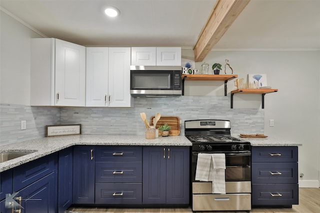 kitchen featuring light stone countertops, blue cabinets, stainless steel appliances, beamed ceiling, and white cabinets