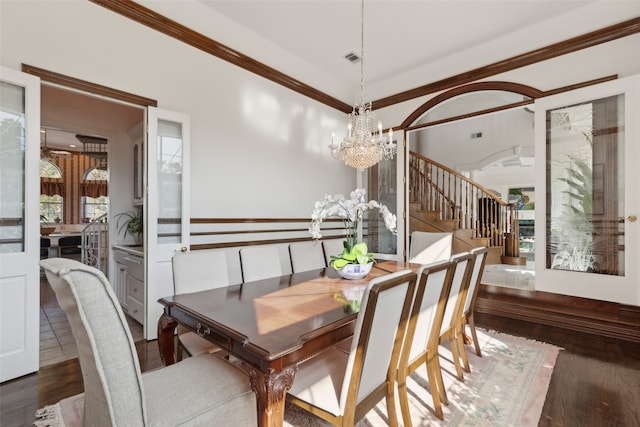 dining area with a notable chandelier, dark hardwood / wood-style floors, and ornamental molding