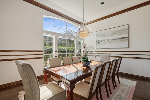 dining room featuring ornamental molding, dark wood-type flooring, and a chandelier