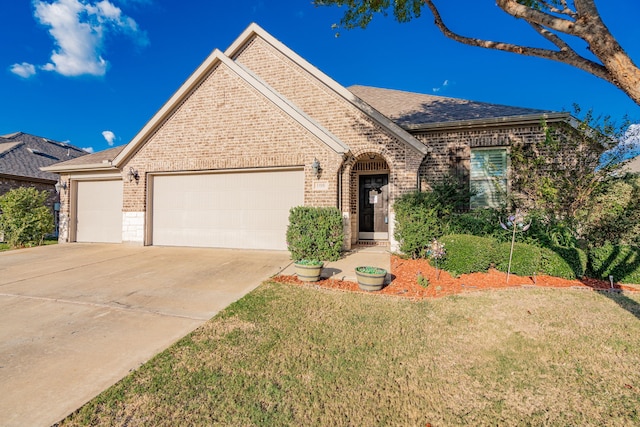 view of front of house with a front yard and a garage