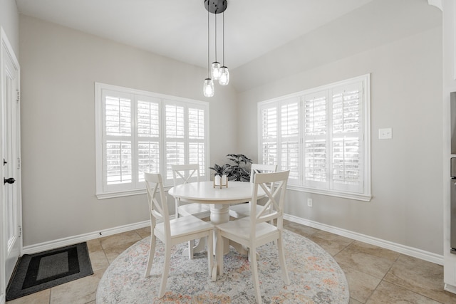 dining room with a wealth of natural light and light tile patterned floors