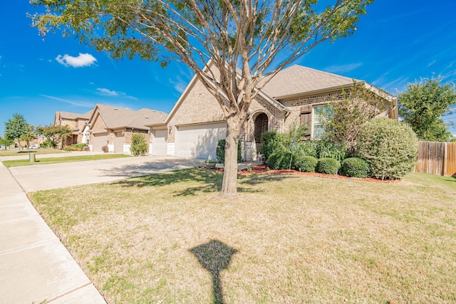 view of front of home featuring a front lawn and a garage