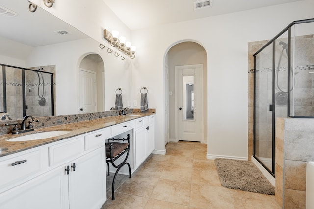 bathroom with vanity and a shower with shower door