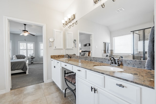 bathroom with a shower with door, vanity, ceiling fan, and tile patterned floors