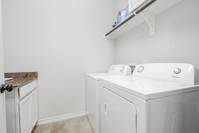 washroom featuring washer and dryer and cabinets