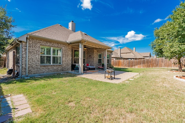 rear view of house with a yard, a patio, and ceiling fan