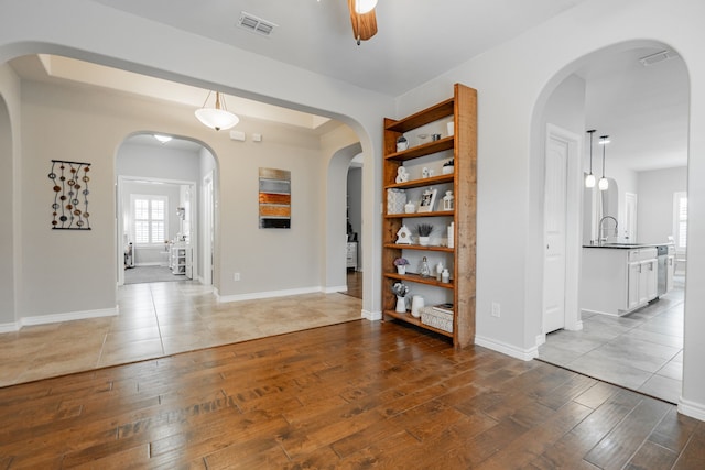 interior space featuring sink, light wood-type flooring, and ceiling fan