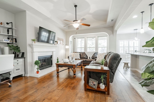 living room featuring light hardwood / wood-style flooring and ceiling fan