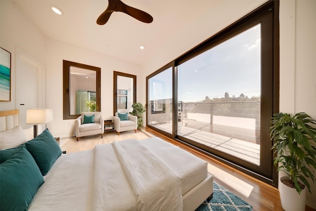 bedroom featuring light hardwood / wood-style floors, multiple windows, access to exterior, and ceiling fan