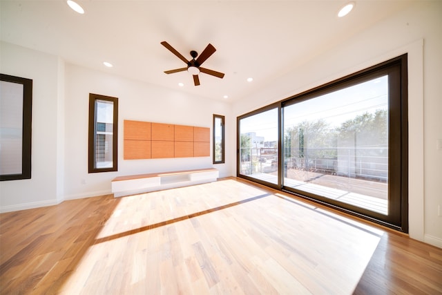 unfurnished living room with light hardwood / wood-style flooring and ceiling fan