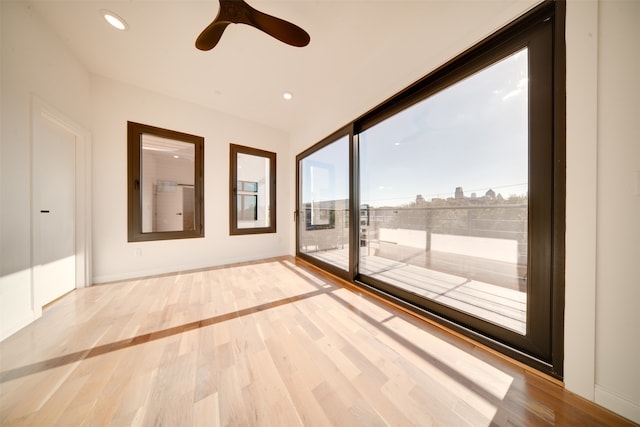 unfurnished room featuring light hardwood / wood-style flooring and ceiling fan