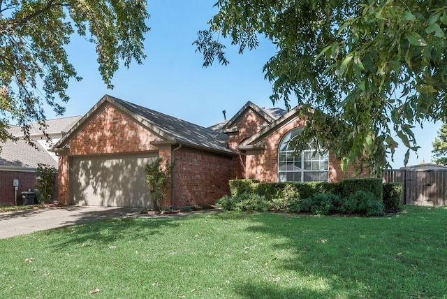 view of front of home with a front yard and a garage