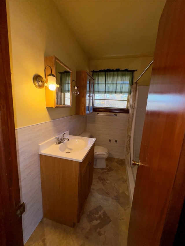 bathroom featuring vanity, toilet, and walk in shower