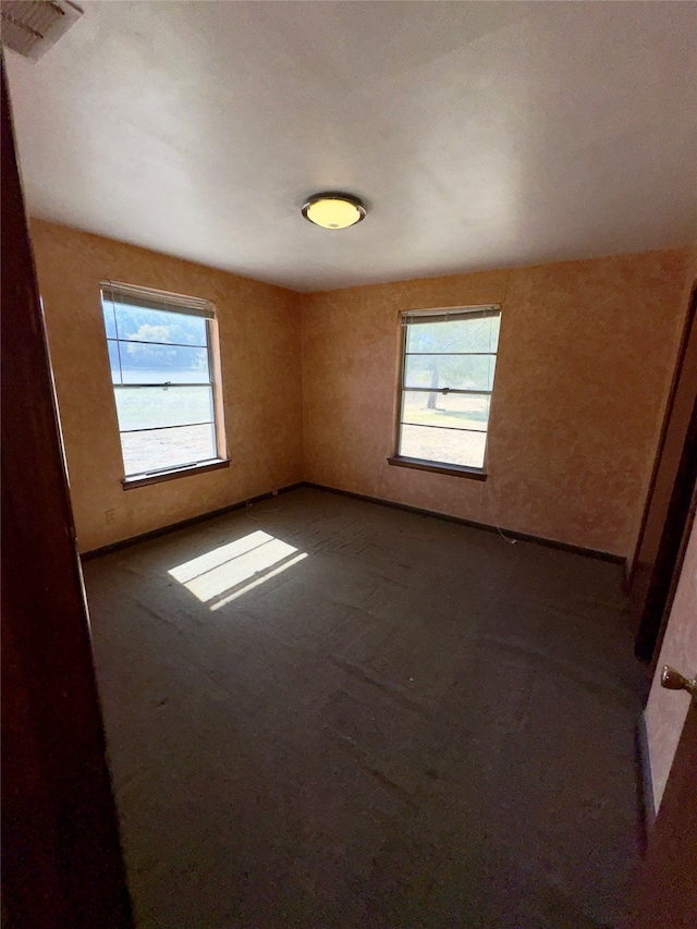 unfurnished room featuring plenty of natural light