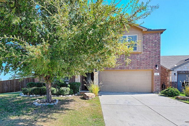 view of property hidden behind natural elements featuring a front lawn and a garage