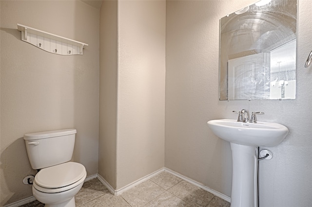 bathroom featuring tile patterned floors and toilet