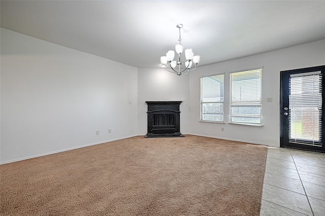 unfurnished living room featuring an inviting chandelier and light tile patterned floors