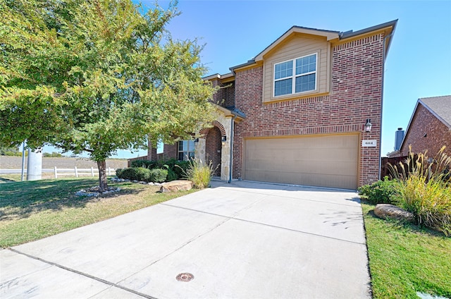 view of front of house with a garage and a front lawn