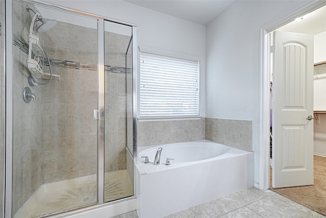 bathroom with separate shower and tub and tile patterned flooring