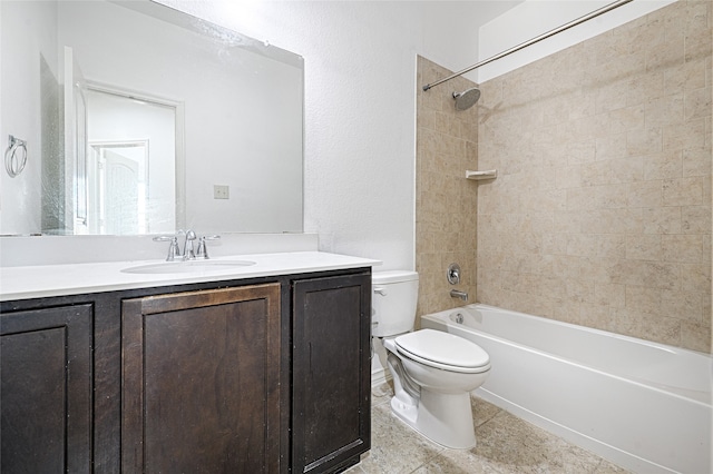 full bathroom featuring tiled shower / bath, vanity, toilet, and tile patterned floors