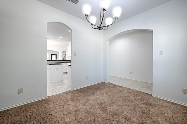 unfurnished room featuring a notable chandelier, sink, and light carpet