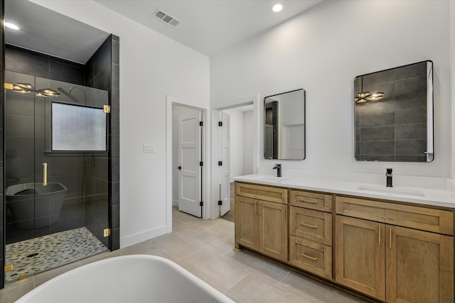 bathroom featuring vanity, independent shower and bath, and tile patterned floors