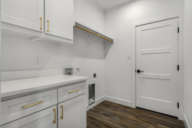 washroom with electric dryer hookup, washer hookup, cabinets, and dark hardwood / wood-style floors