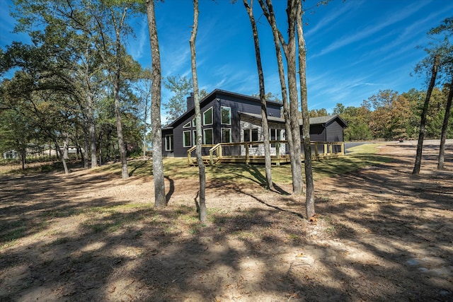 back of property with a wooden deck