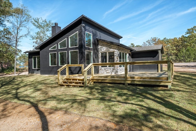 back of property featuring a wooden deck and a yard