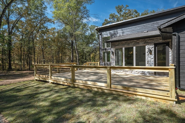 view of property exterior with a wooden deck and a lawn