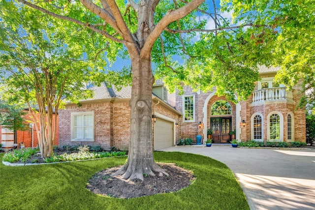 view of front of house featuring french doors, a front yard, and a garage