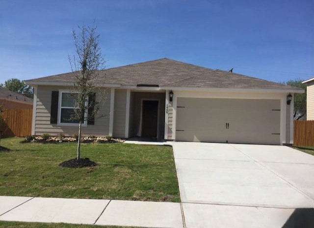 single story home with a front yard and a garage