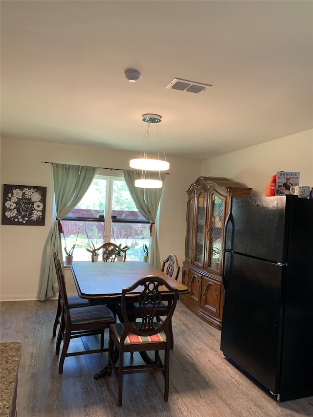 dining area with hardwood / wood-style floors