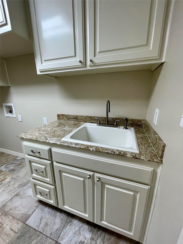 kitchen with white cabinets and a sink