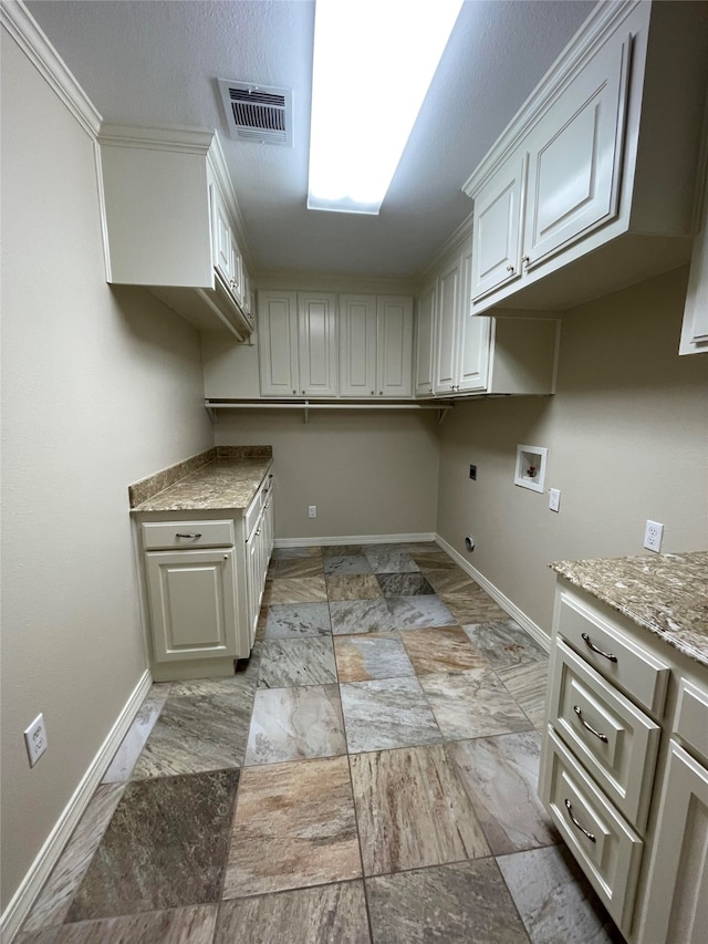 laundry area featuring washer hookup, visible vents, cabinet space, hookup for an electric dryer, and baseboards