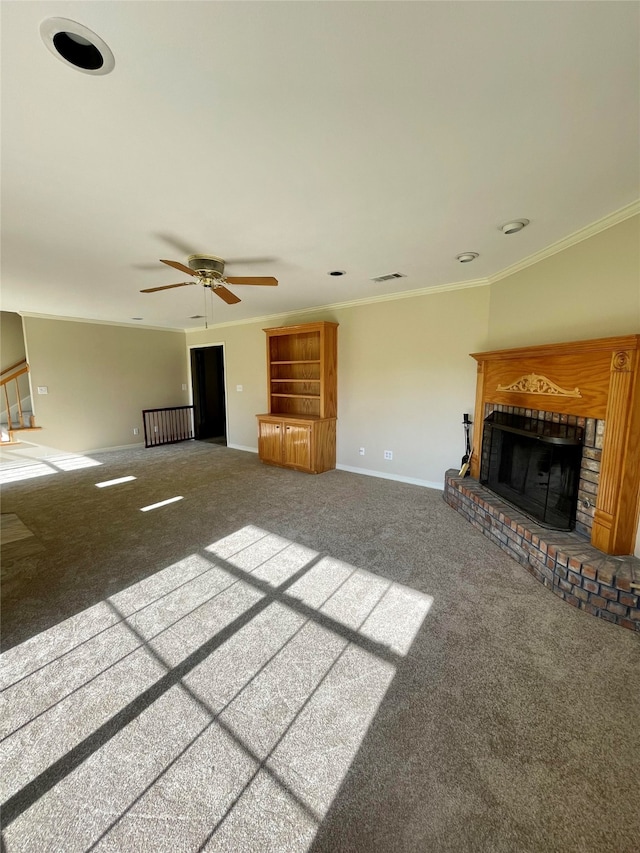 unfurnished living room featuring carpet floors, a fireplace, ornamental molding, a ceiling fan, and baseboards