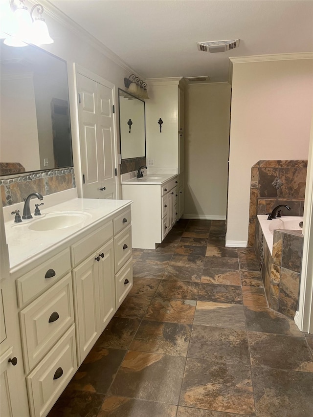 bathroom with a relaxing tiled tub, a sink, visible vents, ornamental molding, and stone finish floor