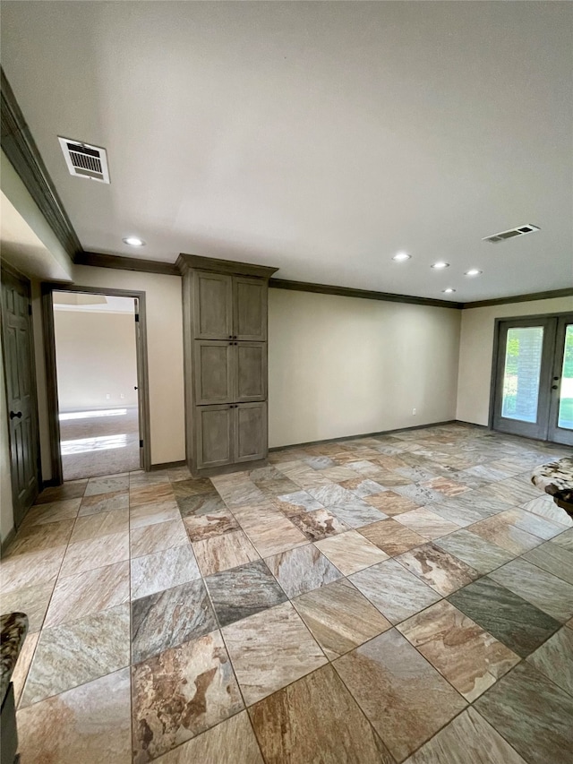 spare room with crown molding and french doors