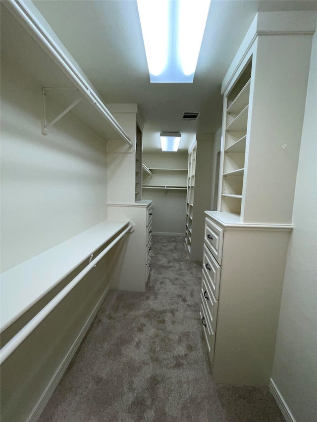 spacious closet with visible vents and dark carpet