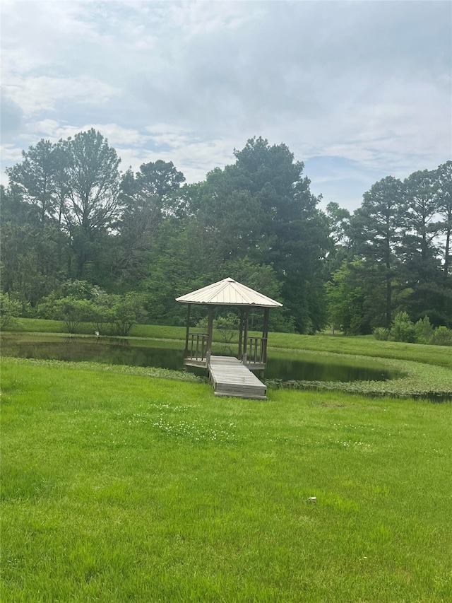 surrounding community featuring a water view, a yard, and a gazebo