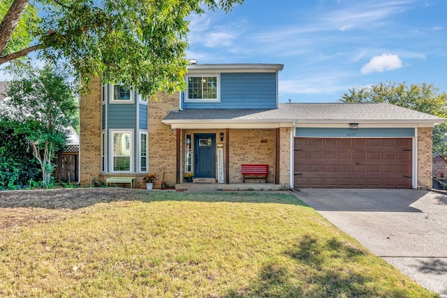 front of property with covered porch, a front lawn, and a garage