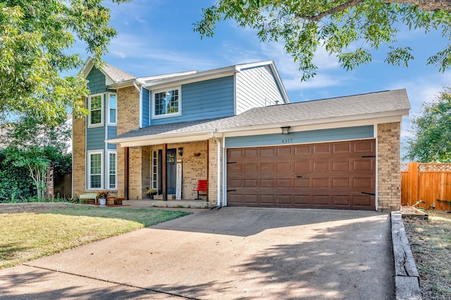 front of property with a front lawn and a garage