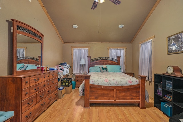 bedroom featuring lofted ceiling, ornamental molding, and light wood-type flooring