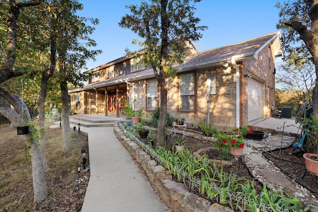 view of front of property featuring stone siding and an attached garage